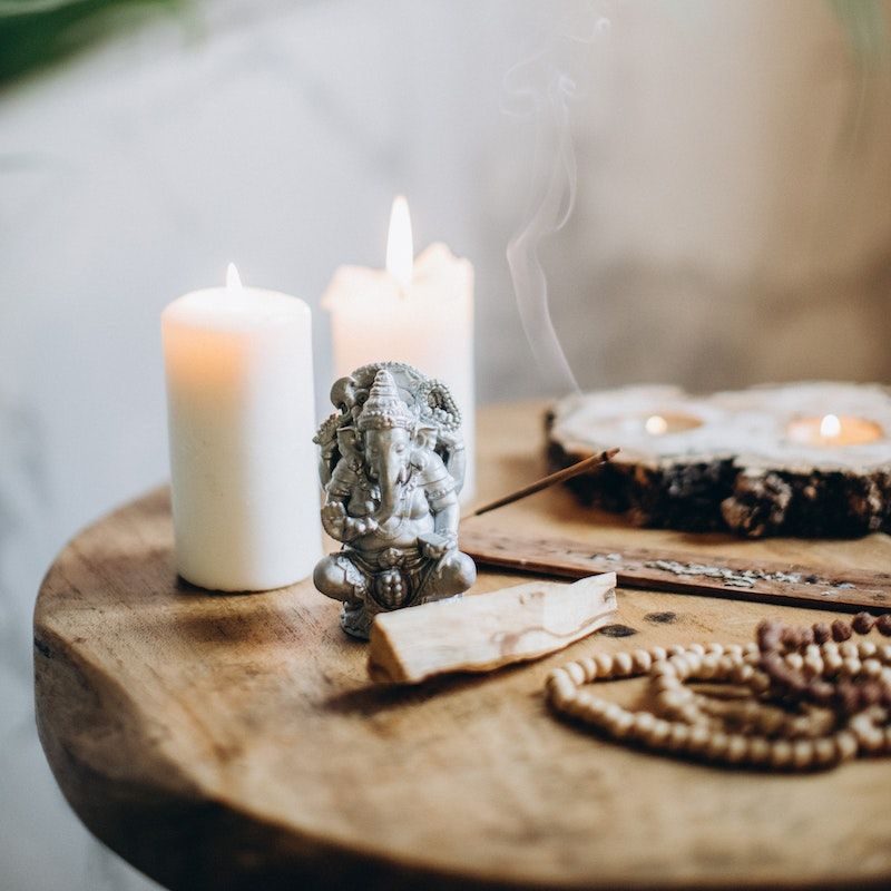 Brown Wooden Table With Candles and Incense